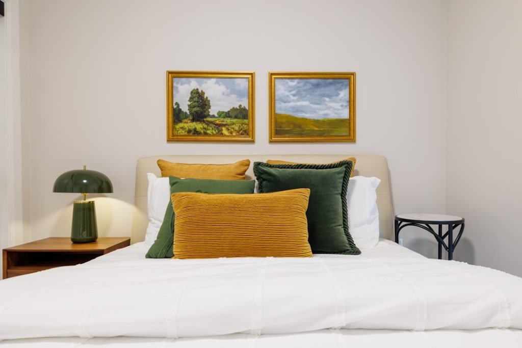 bedroom-with-landscape-paintings-and-green-lamp-mfetnae0e8m