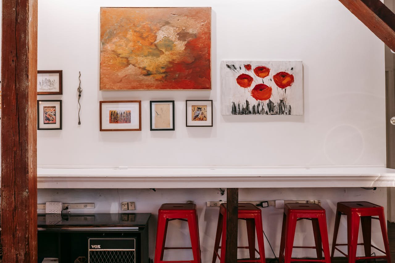 The Art of Drawing Readers In: Your attractive post title goes here Interior of contemporary apartment with white long table near wall with bright drawings in light cozy apartment with wooden beam